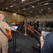 USS Ronald Reagan (CVN 76) Sailors hold a baptism in the Hangar Bay.