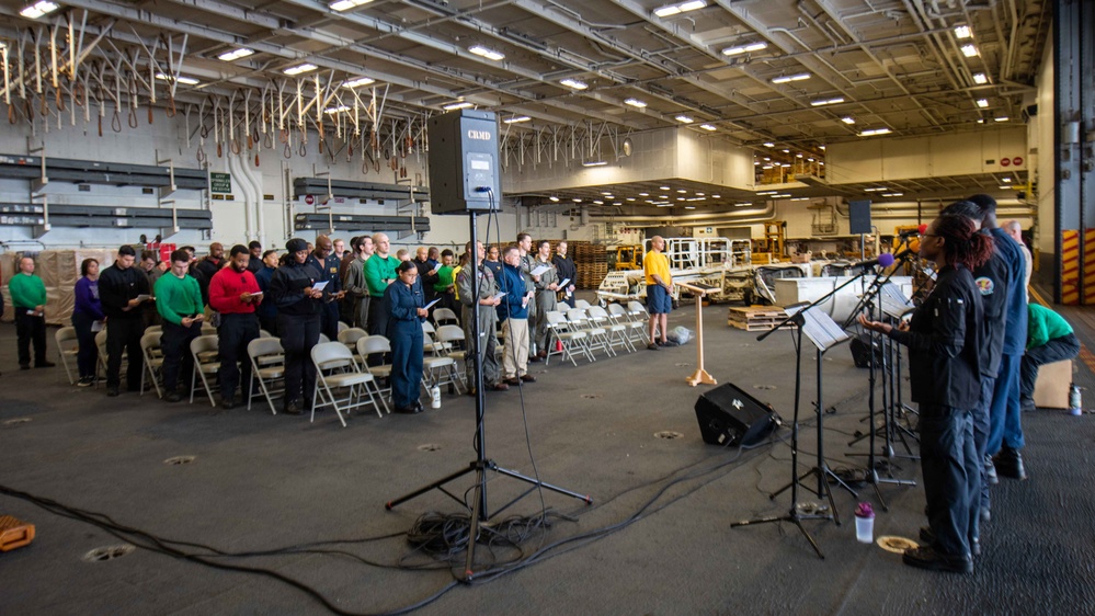 USS Ronald Reagan (CVN 76) Sailors hold a baptism in the Hangar Bay.