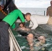 USS Ronald Reagan (CVN 76) Sailors hold a baptism in the Hangar Bay.