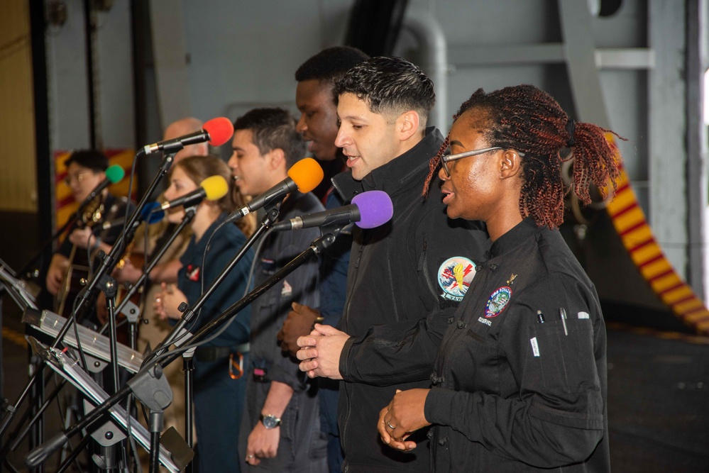 USS Ronald Reagan (CVN 76) Sailors hold a baptism in the Hangar Bay.