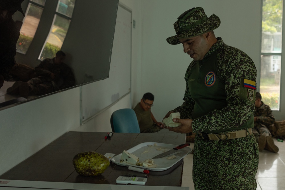 U.S. Marines with Littoral Craft Company Charlie, eat jackfruit with their Colombian Marine Corps Instructor