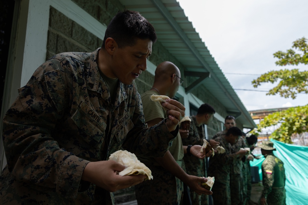 U.S. Marines with Littoral Craft Company Charlie, eat jackfruit with their Colombian Marine Corps Instructor