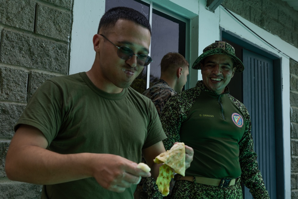 U.S. Marines with Littoral Craft Company Charlie, eat jackfruit with their Colombian Marine Corps Instructor