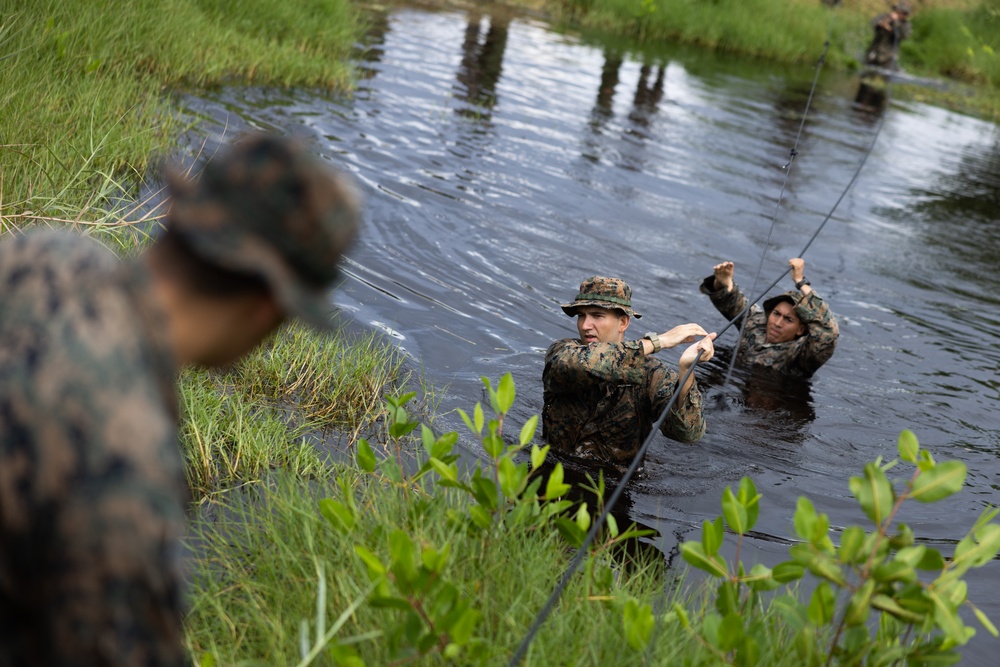 U.S. Marines with Littoral Craft Company Charlie participate in an exercise gauntlet during the Colombian Fluvial Operations Course