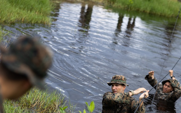 U.S. Marines with Littoral Craft Company Charlie participate in an exercise gauntlet during the Colombian Fluvial Operations Course