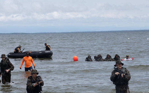 U.S. Marines with Littoral Craft Company Charlie participate in an exercise gauntlet during the Colombian Fluvial Operations Course
