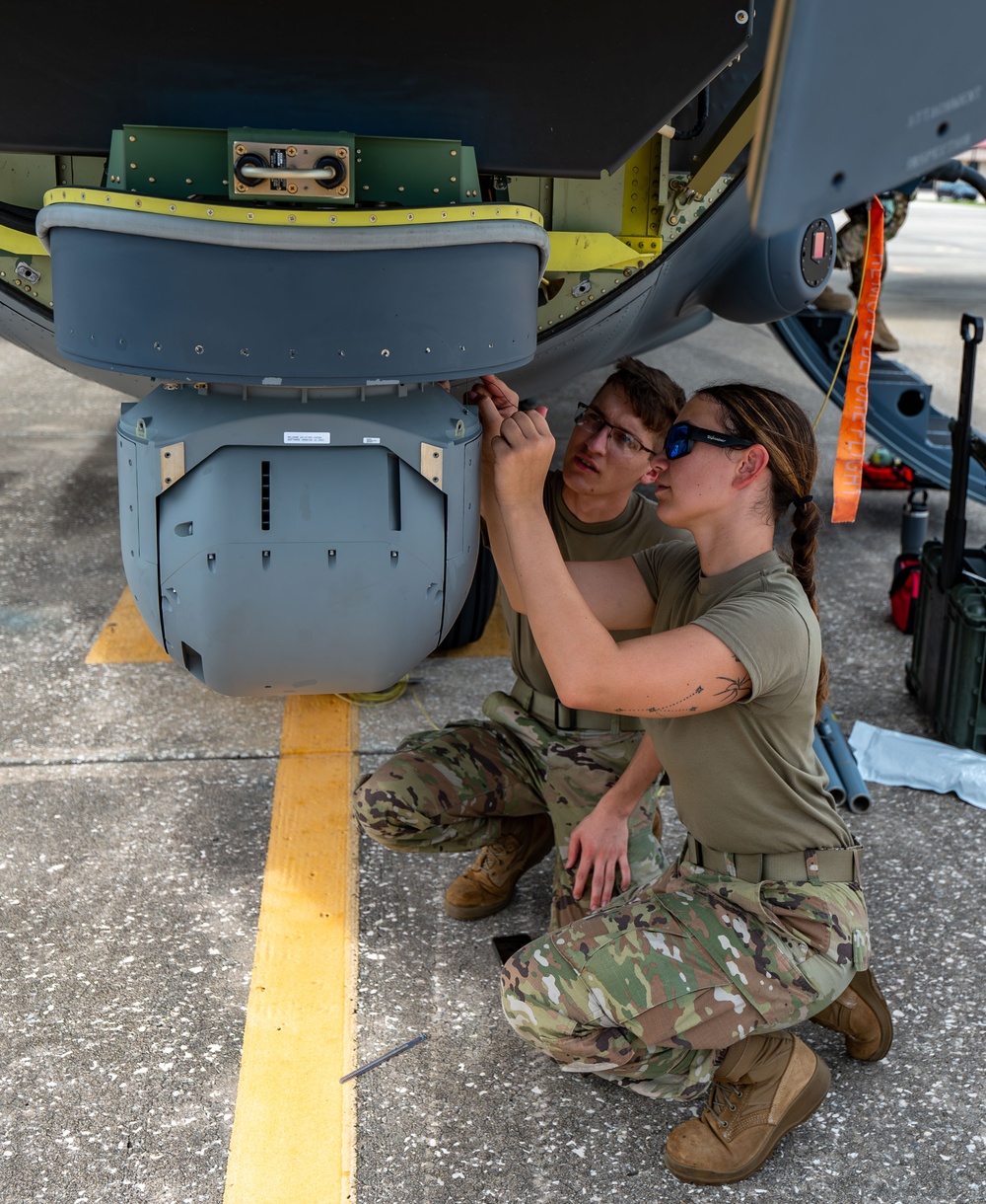 Installation of safety cables on the turret of the HC-130J Combat King II aircraft