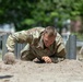 Sgt. Thomas Doles crawls through an obstacle