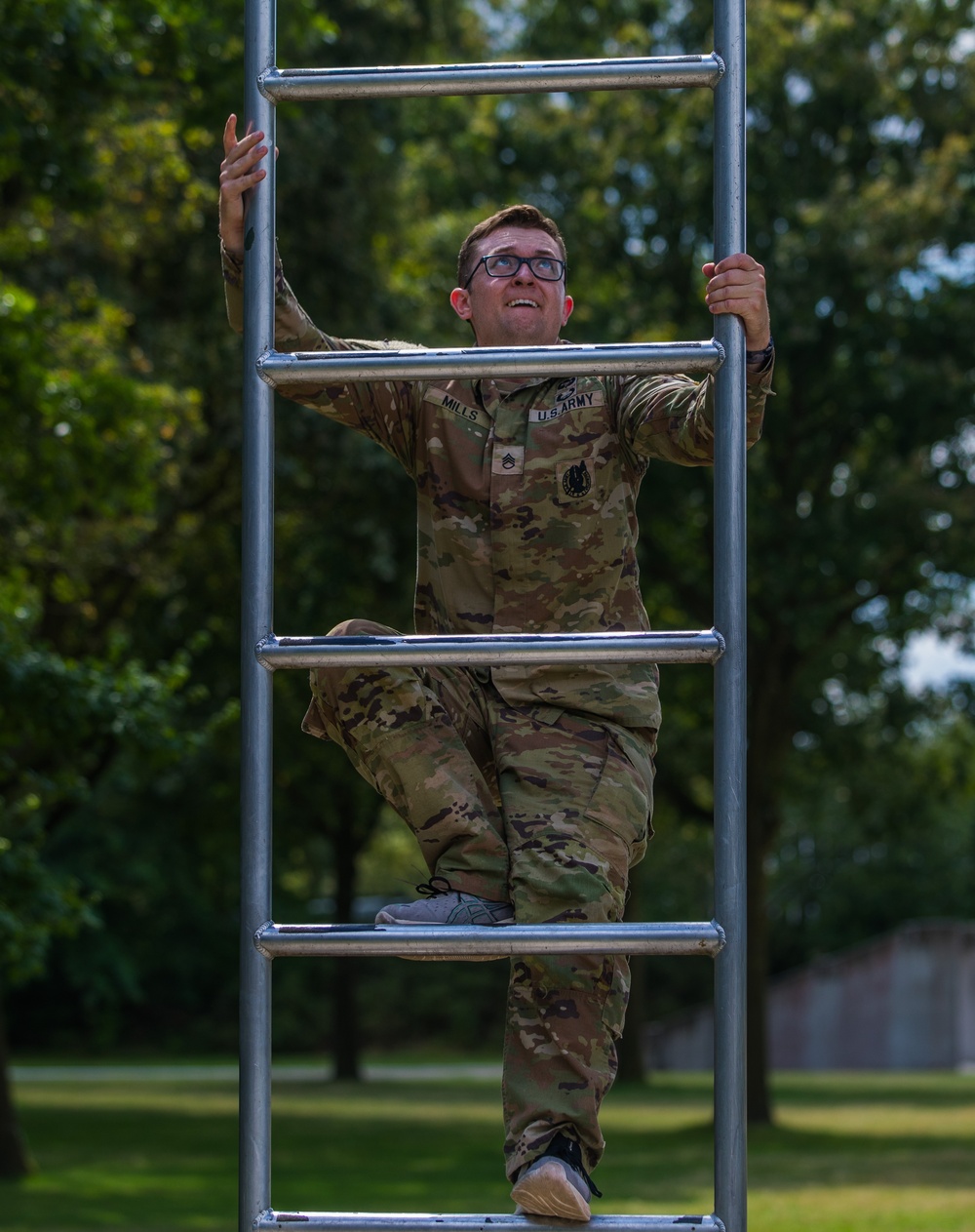 Staff Sergeant Zachary B. Mills climbs an obstacle