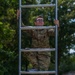 Staff Sergeant Zachary B. Mills climbs an obstacle