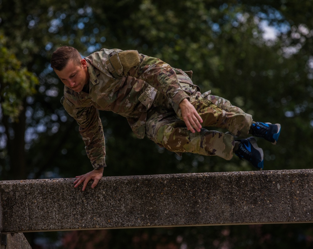 Staff Sergeant Conner J. Williams bounds over an obstacle