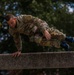 Staff Sergeant Conner J. Williams bounds over an obstacle