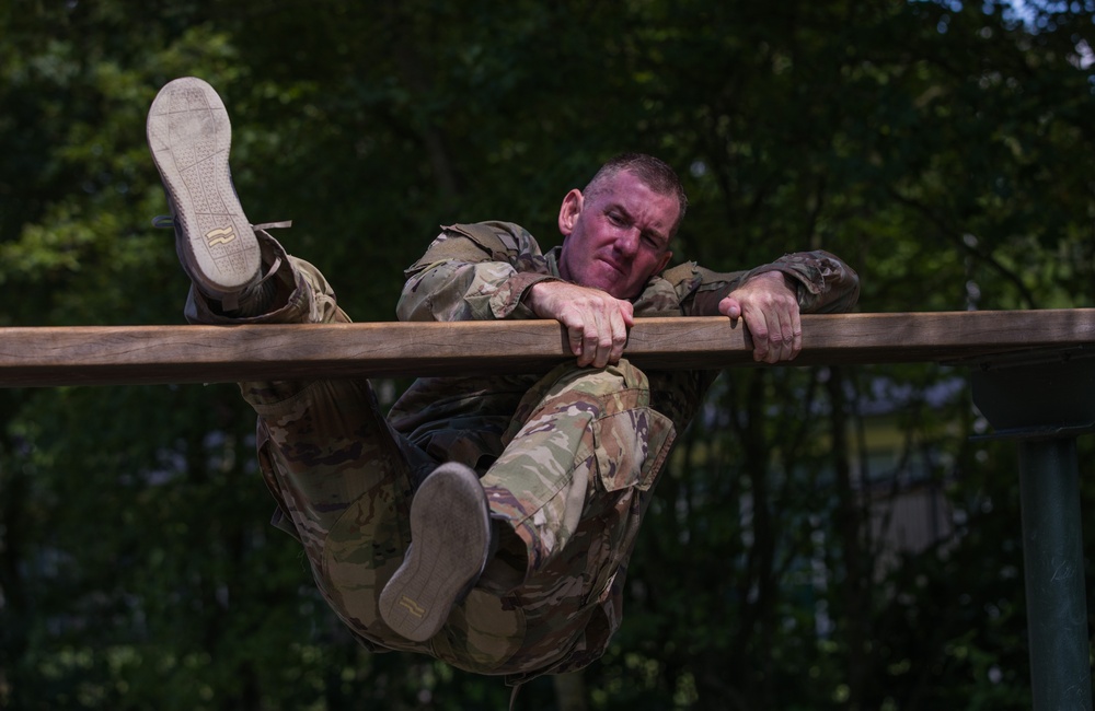 Captain Zachary C. Grimes maneuvers over an obstacle