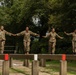 Service members negotiate a balance obstacle