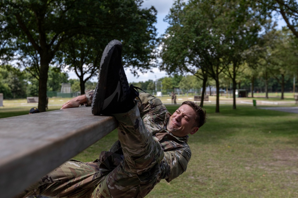 Sgt. 1st Class Benjamin Latham tries to get over an obstacle