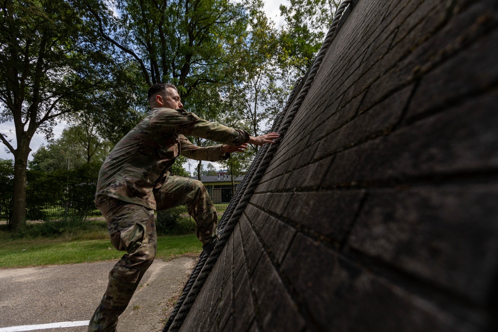 1st Lt.  Michael Vigh climbs an obstacle