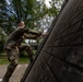 1st Lt.  Michael Vigh climbs an obstacle