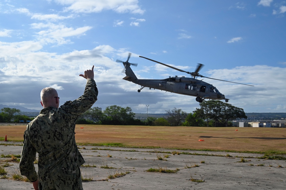 VADM Wade waves at MH-60S Sea Hawk Helicopter during RIMPAC 2024