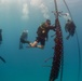 U.S. Coast Guard and Republic of Korea Navy Underwater Construction Team divers recover a sunken buoy during RIMPAC 2024