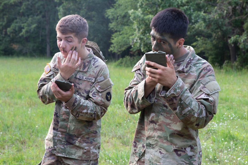 Iowa Soldiers apply face paint ahead of Zodiac boat operation