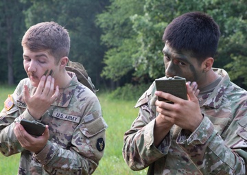 Iowa Soldiers apply face paint ahead of Zodiac boat operation