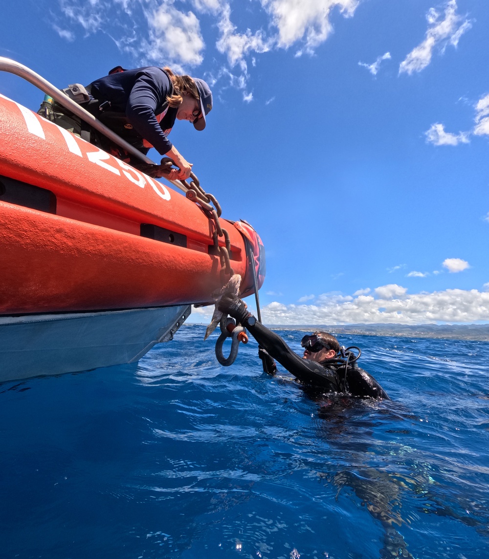 U.S. Coast Guard and Republic of Korea Navy Underwater Construction Team divers recover a sunken buoy during RIMPAC 2024