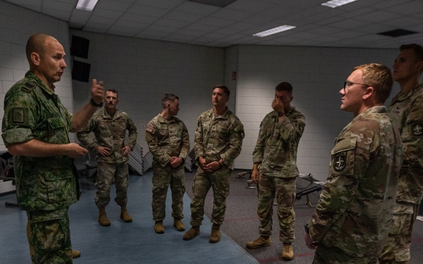 Sgt. Maj. Rik De Jager speaks with memebers of the U.S. CIOR team