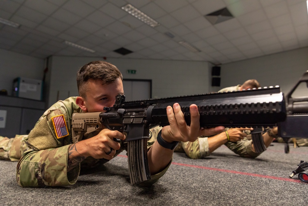 Sgt. Trenton Tuberosa fires a Colt C7NLD simulation rifle