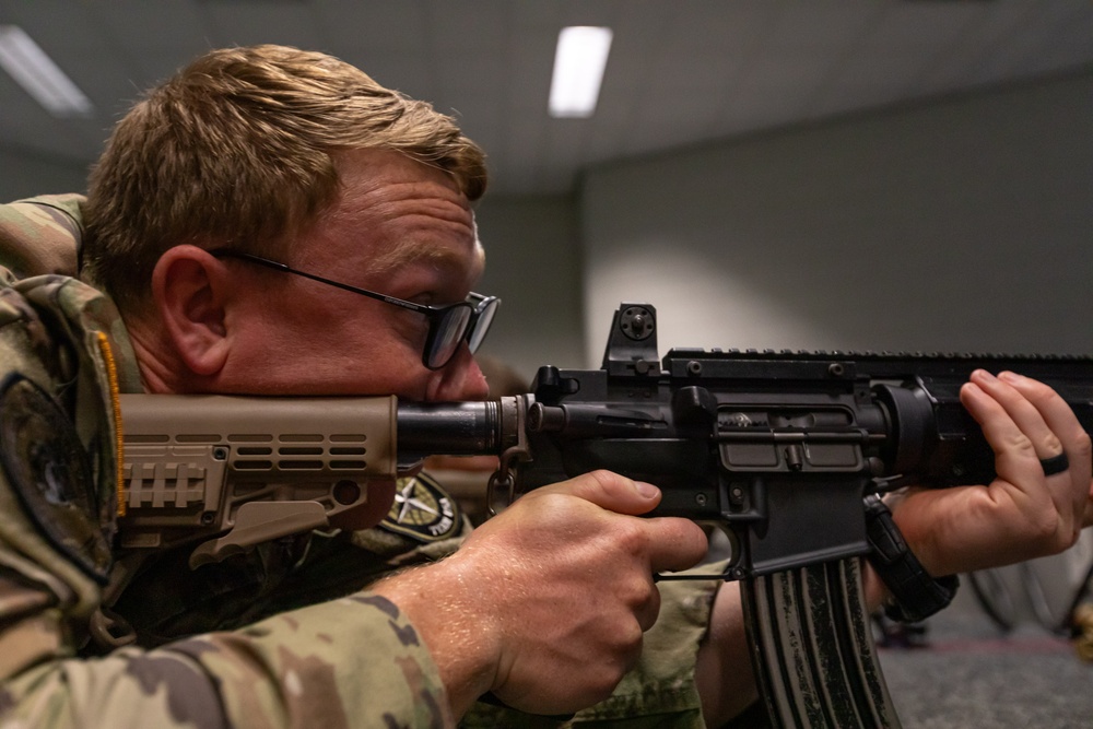 Sgt. Thomas Hunt fires a Colt C7NLD simulation rifle
