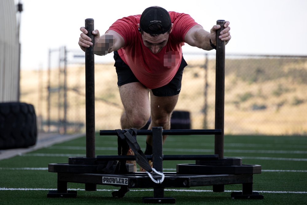 10th SFG(A) Soldier pushes sled for Fittest Original