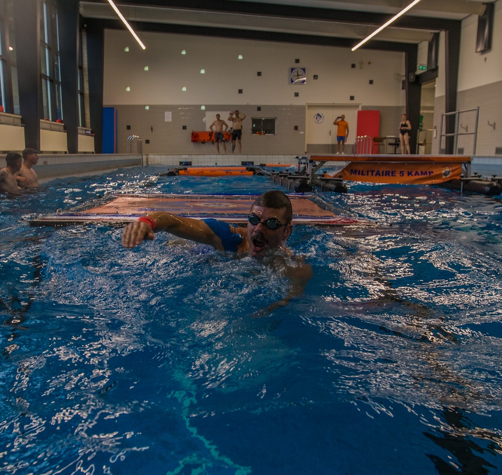 Lieutenant Colonel James M. Fink navigates a practice swim obstacle course