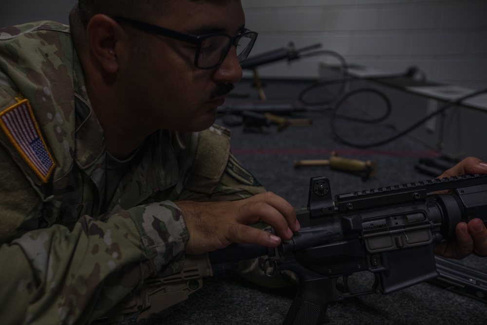 Sergeant First Class David J. Duran conducts a safety check on a simulated rifle