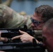 Col. Brent Dishman aims a simulated Colt C7NLD rifle