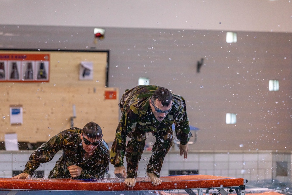 USA team members go over an obstacle