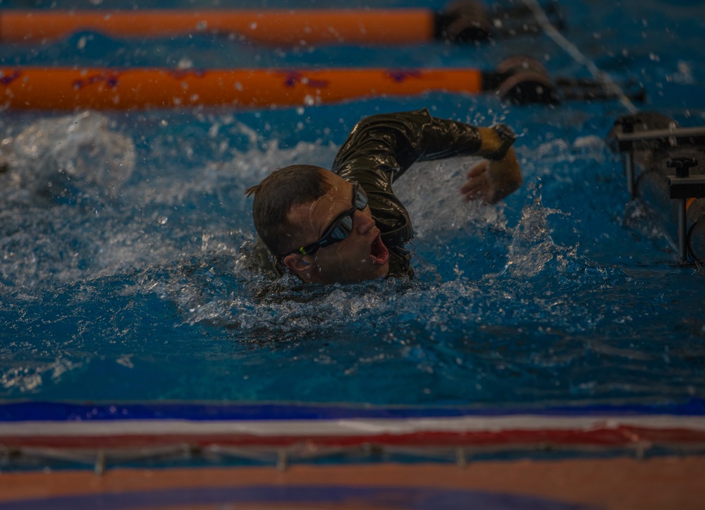 Sergeant Thomas S. Doles prepares to swim under an obstacle course barrier