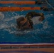 Sergeant Thomas S. Doles prepares to swim under an obstacle course barrier