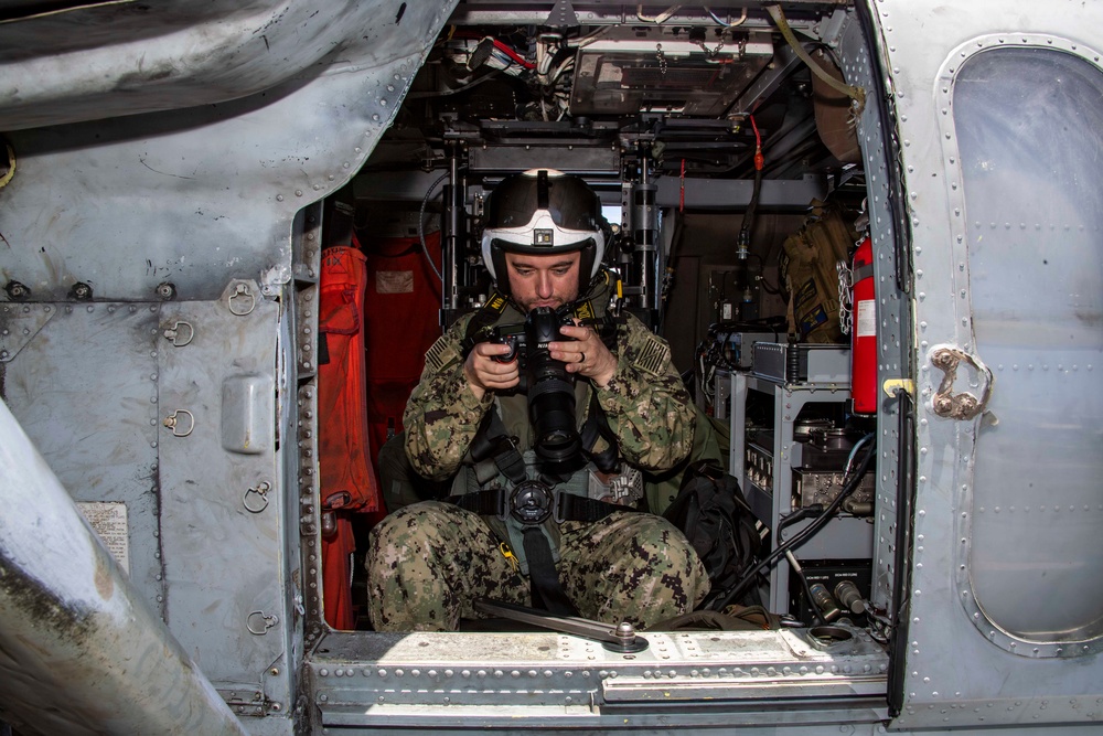 USS Carl Vinson (CVN 70) sailor participates in RIMPAC 2024 photo exercise