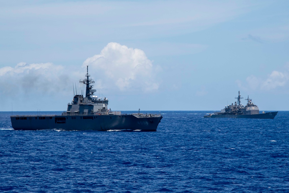 Japan Maritime Self-Defense Force amphibious transport dock ship JS Kunisaki (LST 4003) and Ticonderoga-class guided-missile cruiser USS Princeton (CG 59) steam alongside each other during Exercise Rim of Pacific (RIMPAC) 2024 photo exercise.