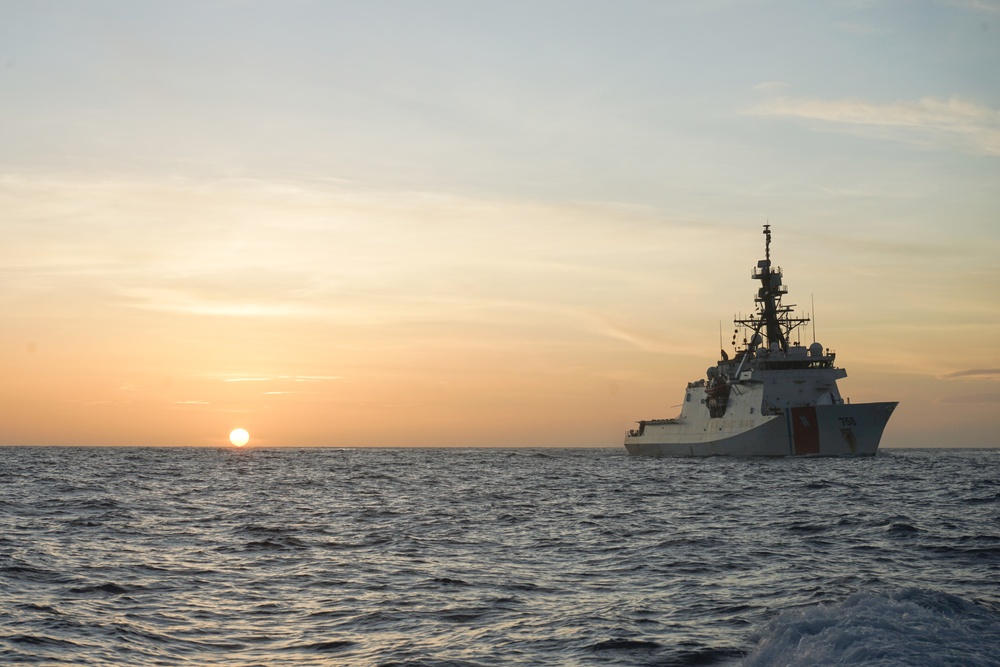 Coast Guard Cutter Stone steams at sunset in the Atlantic Ocean