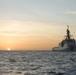 Coast Guard Cutter Stone steams at sunset in the Atlantic Ocean