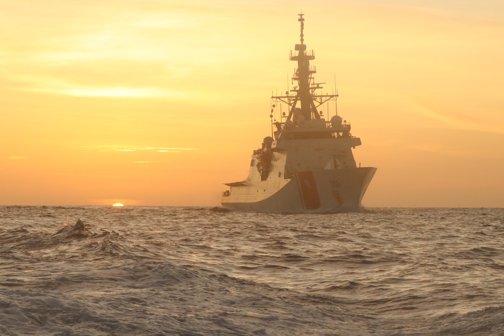 Coast Guard Cutter Stone steams at sunset in the Atlantic Ocean