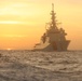 Coast Guard Cutter Stone steams at sunset in the Atlantic Ocean