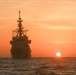 Coast Guard Cutter Stone steams at sunset in the Atlantic Ocean