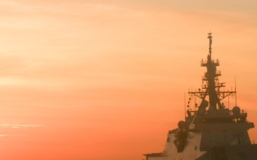 Coast Guard Cutter Stone steams at sunset in the Atlantic Ocean
