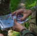 Service members representing team USA shoot an azimuth during a practice orienteering event