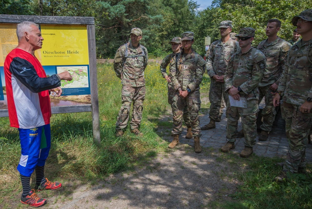 Service members representing team USA receive a brief before an orienteering event