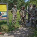 Service members representing team USA receive a brief before an orienteering event