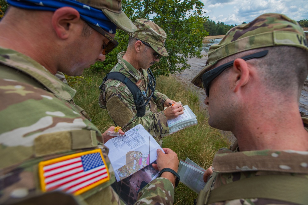 Service members representing team USA check their map to acquire their next control