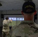 Sgt. 1st Class Kristoffer Friend watches 1st Lt. Brianna Mirmina fires a Glock 17 simulation pistol