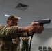 Sgt. 1st Class Benjamin Latham fires a Glock 17 simulation pistol